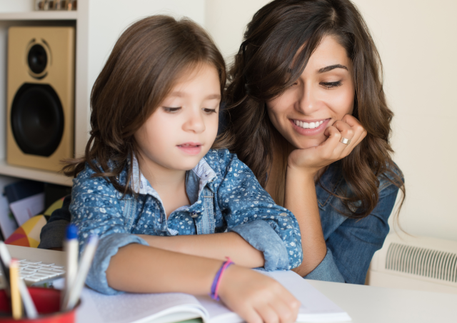 a child practices reading with her mother - maybe after she'll practice tracing some sight words